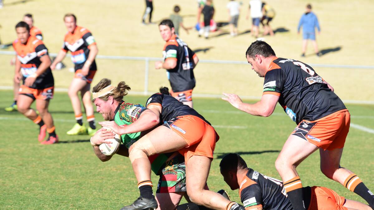 Caught: Rabbitohs front rower Ty Blanchett is dragged down by the Nyngan defence. Photo: PAIGE WILLIAMS