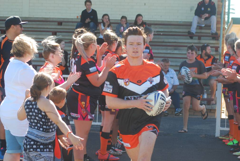 UNDER 18s: Zach Waterhouse leads the boys on to the field.