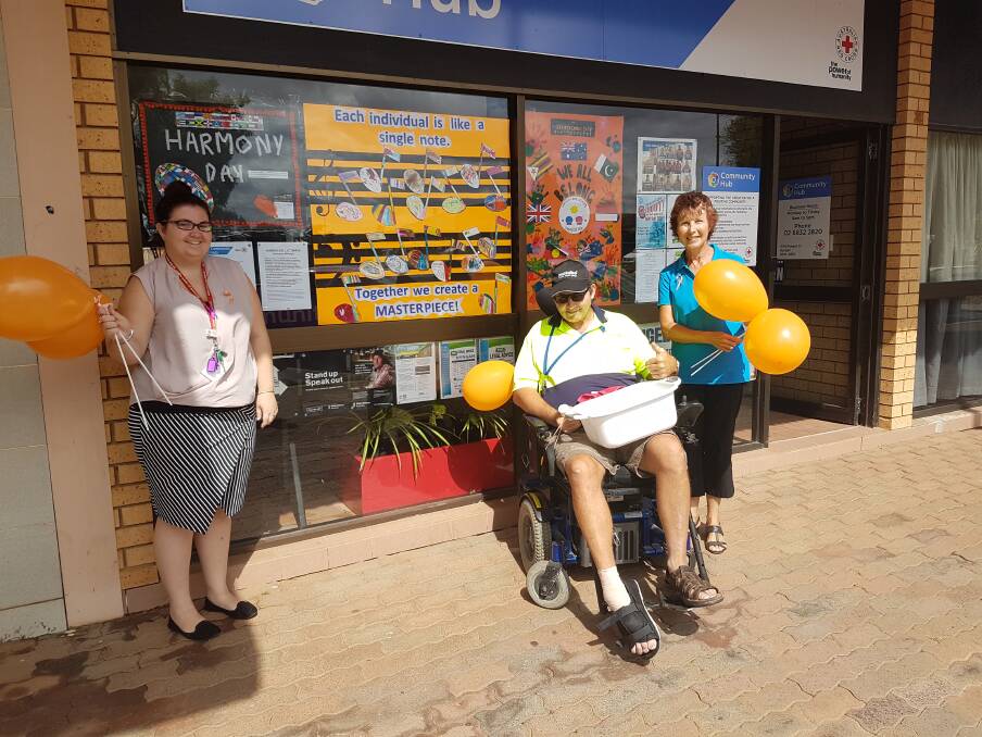 IN HARMONY: Community Hub's Katie White, postie Mick McGlynn and Ability Linkers Wendy Beetson spreading the news about Harmony Day out the front of the beautifully decorated Community Hub on Tuesday. Photo: GRACE RYAN. 