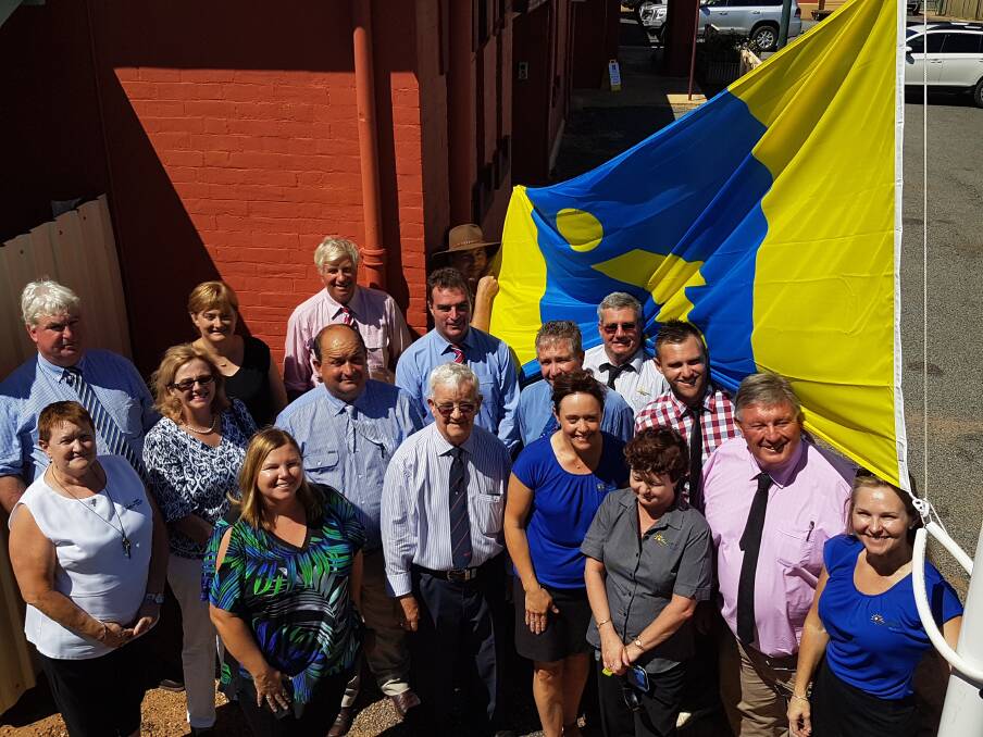 VIC FLAG: Bogan Shire Councillors and managers raising the flag at the Visitor Information Centre. Photo: GRACE RYAN. 