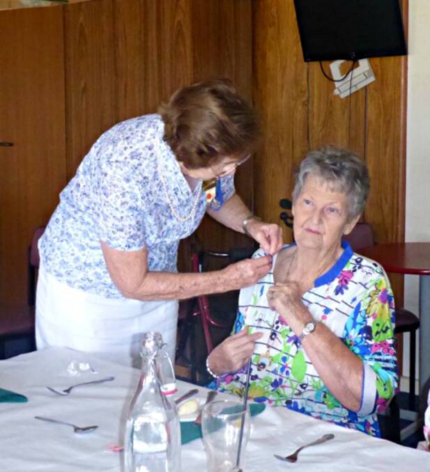 ACKNOWLEDGED: Vice-president Vernette pinning 20 year badge on Joy last month. Photo: CONTRIBUTED. 