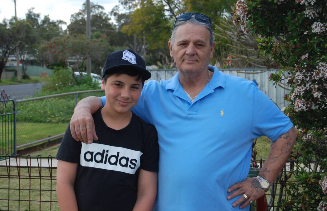NEW LIFE: Steven Grainger (right) with grandson Jayden outside his Nyngan home. Mr Grainger is turning his life around after his difficult childhood plagued with horrific experiences. Photo: GRACE RYAN.