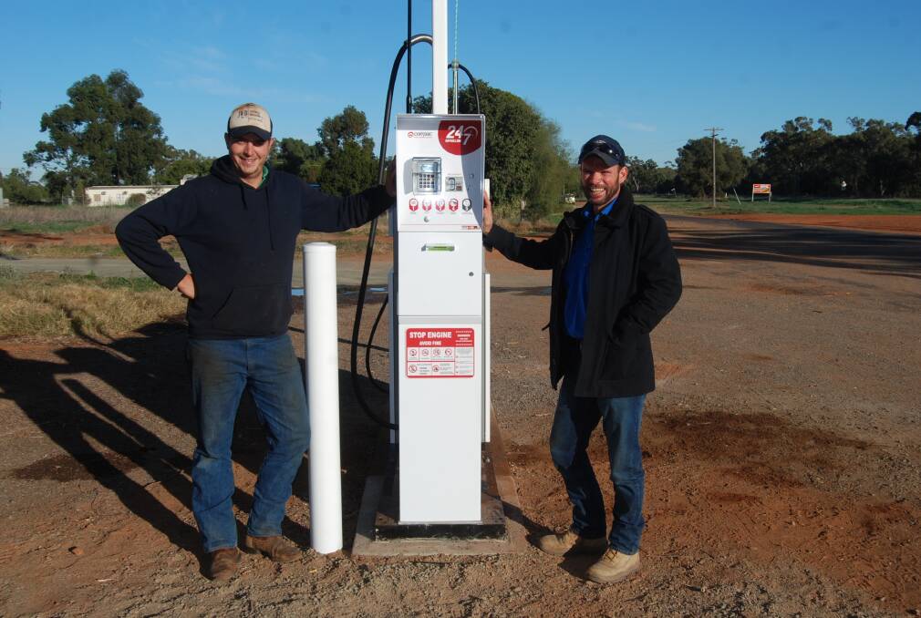 24 HOUR FUEL STATION: Michael Wells-Budd and Dom Ward are happy at the pump at the Hermidale Hotel. Photo: GRACE RYAN. 