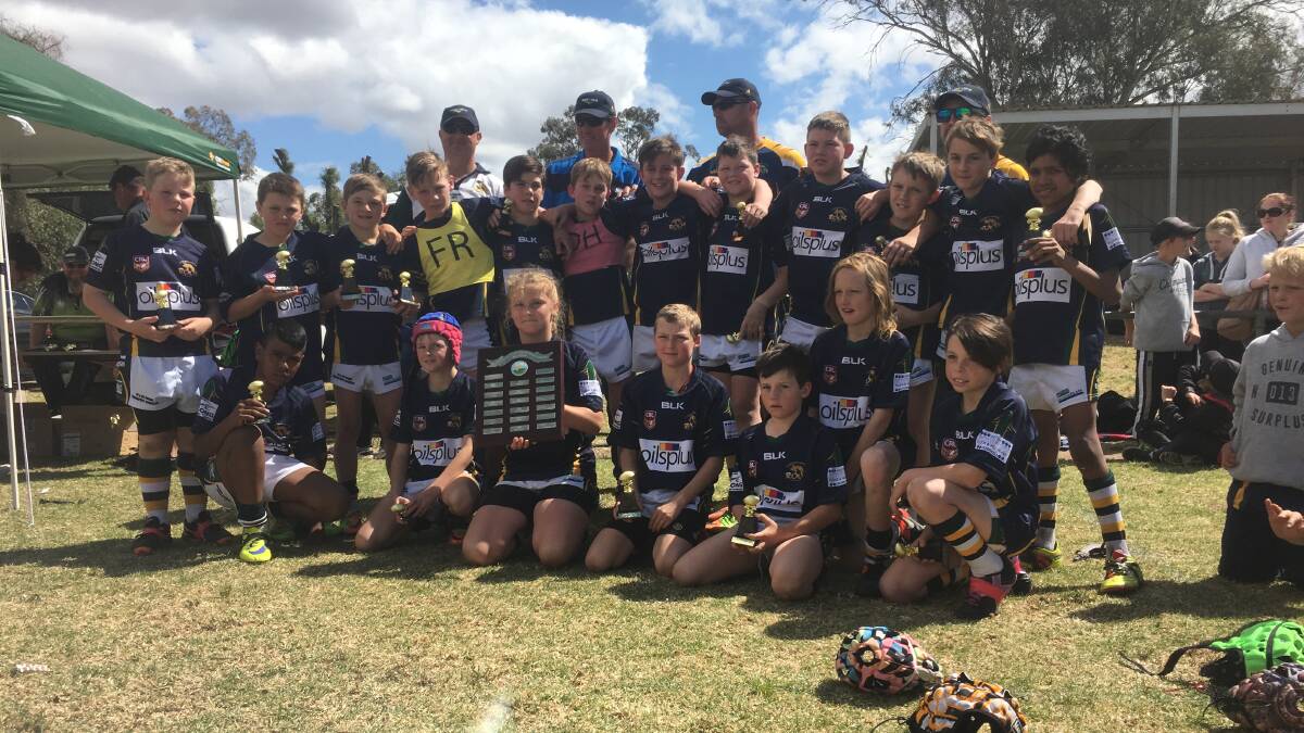 WE ARE THE CHAMPIONS: The Cabonne Roos' under 12s side celebrating the club's first title. Photo: KATIE FOY
