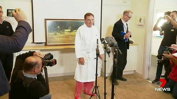 Ipswich mayor Paul Pisasale, wearing a hospital gown and pyjamas, announces his resignation. Photo: 7 News

