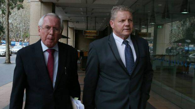 Craig Izzard (right) leaves ICAC in September 2016, after giving evidence into allegations he turned a blind eye to asbestos dumping in his role at a western Sydney Council. Photo: Louise Kennerley
