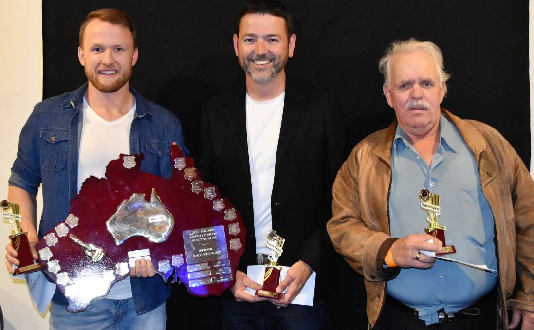 CLEANING UP: Derek Thompson accepting the award for Senior Male Vocal winners alongside fellow competitors 2nd Bruce Tasker (2nd) and Alex Winnell (3rd) at the Parkes Country Music Festival. Photo: JENNY KINGHAM