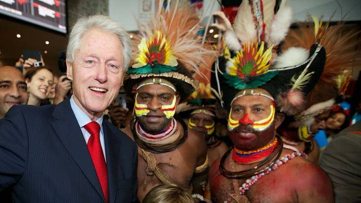 Former US president Bill Clinton poses with AIDS 2014 conference delegates from the Southern Highlands of Papua New Guinea. Photo: Jason South