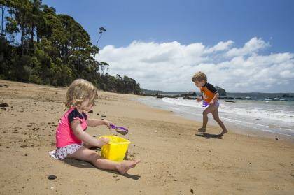 Maddy, 2, and Casey Matthews-James, 4, from England enjoy an outing to Batemans Bay this week. The temperatures will start to climb from Saturday, reaching the mid-30s in western Sydney. Photo: Matt Bedford