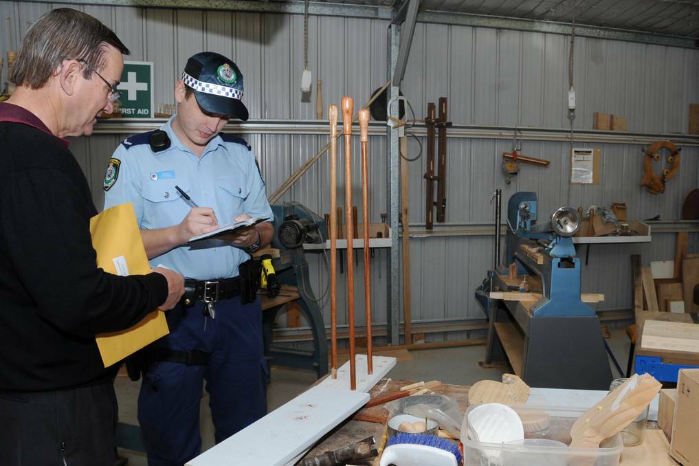 Dubbo Woodturning and Woodcrafting club treasurer Charles Fletcher reports the robbery to Constable Izaak Piepers from Dubbo Police. Photo: BELINDA SOOLE