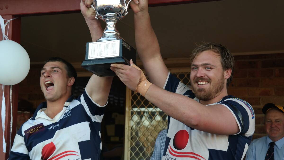 Dom Kennedy and Bryan Perry hold the trophy with pride after a great win in the grand final against Warren on Saturday. 	Photo: TONY WOOD
