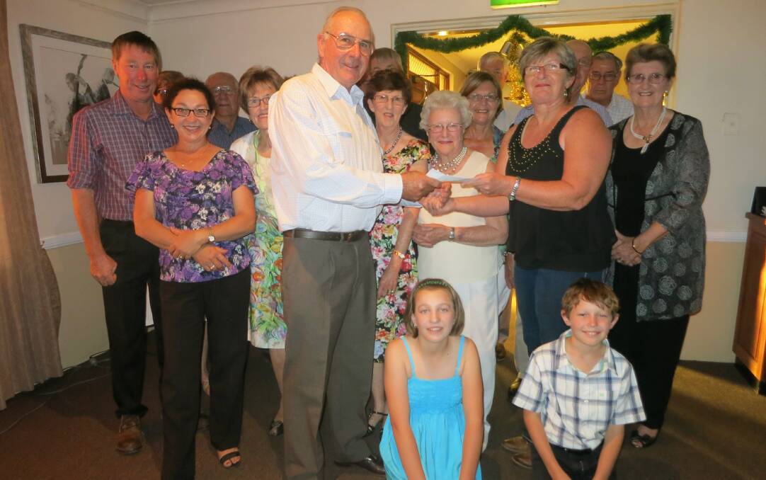 o Clyde Cook, from the Nyngan Social Dance Group, presenting a cheque to Rhonda Baden, President of the Nyngan Hospital Auxiliary.