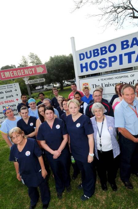 o NSW Nurses and Midwives Association Dubbo Hospital branch members (front) Julie Anderson, Natalie Magill, Amber Diamond, Lorraine Keher, Richard Bolton and their colleagues gather to urge hospital management to fill vacancies in the emergency department. 	Photo: LOUISE DONGES