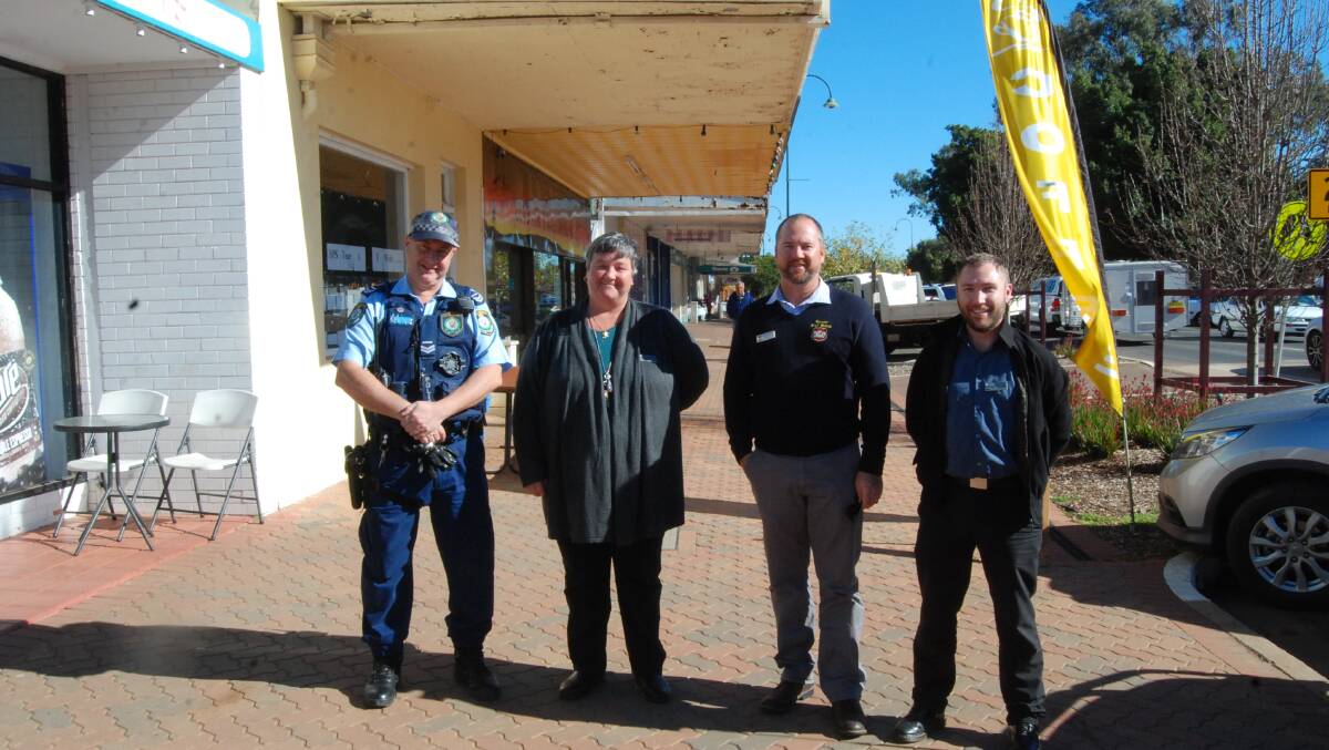 SMILING FOR ATTENDANCE: Senior Constable Craig Skene, Youth Command, Department of Education Home School Liaison Officers Tina Heterick and Clinton Hoy (end) and High School Principal Michael Gibson (second from right) Photo: GRACE RYAN. 