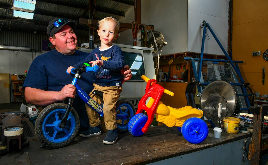 BIG HEART: Matthew Richards with his son Max, 2, and Max's beloved bike. Picture: Scott Gelston 