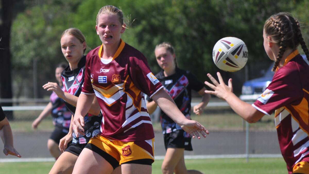 OUT THE BACK: Taylor Keppie passes the ball wide during Saturday's grand final. Photo: NICK McGRATH