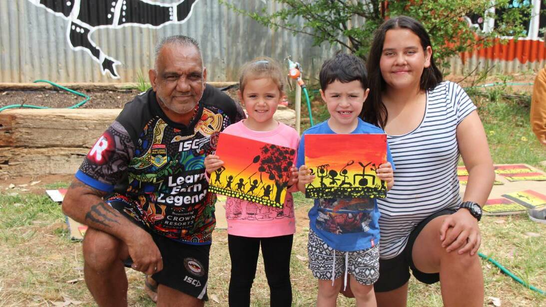 Kids show off their artwork skills with local Trangie artist David Dunn. Photo: FILE