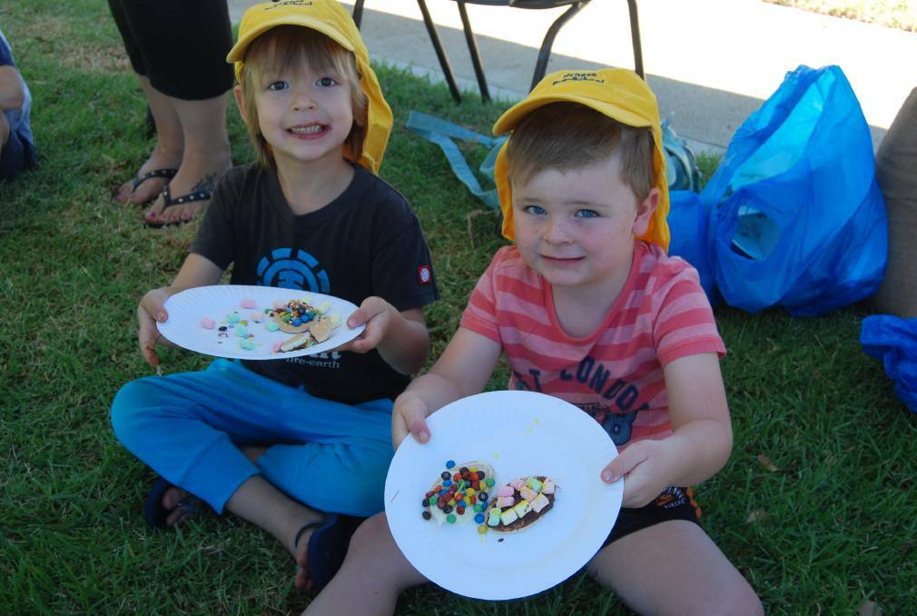 EGG-CELENT: Tommy Black and Tanna Bodanski enjoying their decorated biscuts at last year's community Easter party. Photo: ZAARKACHA MARLAN