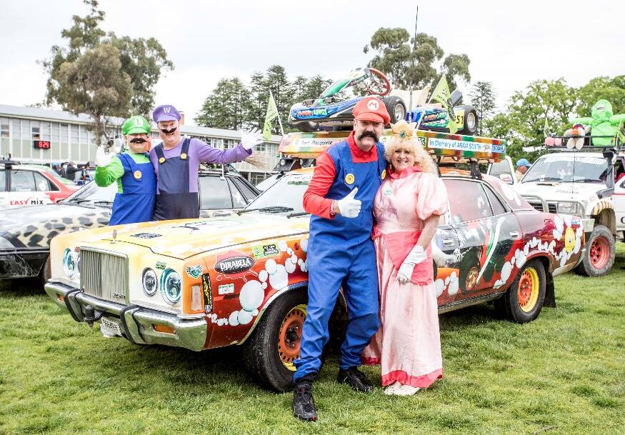 WACKY ADVENTURE: Marcus Hughes with wife Margaret and the team with their ‘Mario and Luigi’ esCarpade car in 2017. Photo: CONTRIBUTED
