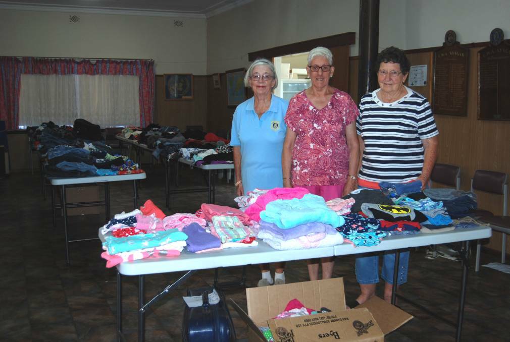  DROUGHT RELIEF: Mary Lamph and Margaret McGlynn with Kay Taylor setting up the CWA hall for the open morning. Photo: ZAARKACHA MARLAN