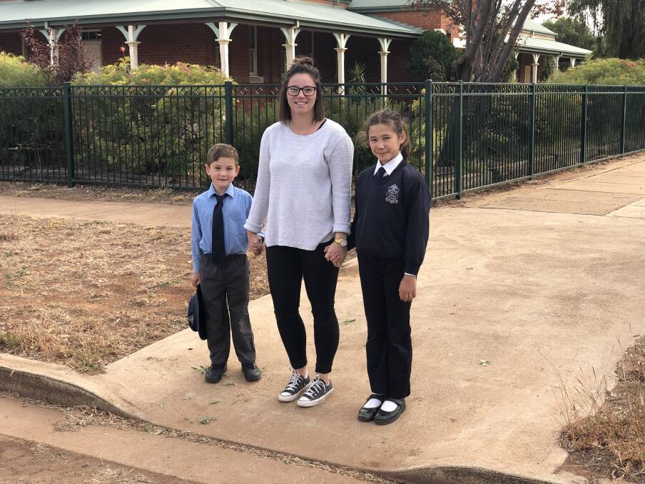 FEET FIRST: Ned and Ruby Carter walk to school safely with Ms Amy Beetson on Friday. Photo: Zaarkacha Marlan