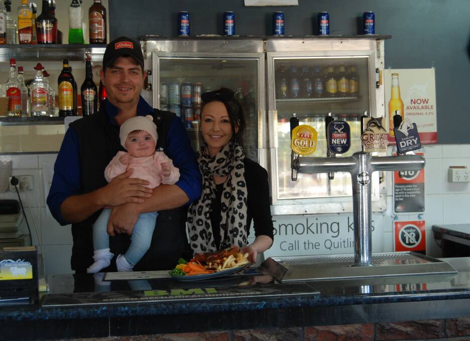PARMA FOR A FARMER: Hermidale Hotel owners Michael and Stacey Wells-Budd with their 4 month old Charlotte who has never seen rain. Photo: ZAARKACHA MARLAN