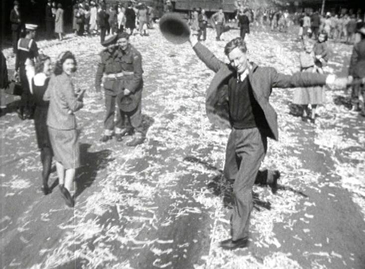 DANCING MAN: This now-famous still from a newsreel features an anonymous man dancing on the street in Sydney, Australia, after the end of WWII. It was featured on a 2005 commemorative $1 coin.