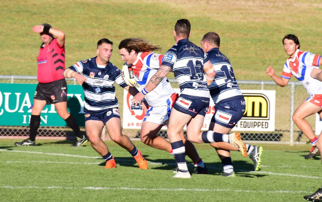 TAKE THEM ON: Parkes' Jay Slavin attempts to barge his way through the Raiders defence on Saturday. Photo: AMY McINTYRE