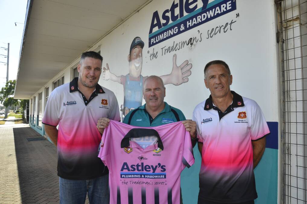 MEN IN THE MIDDLE: Group 11 referees Simon Hartas and Willy Barnes with Craig Haylan of Astley's Plumbing and Hardware, a business which has now been sponsoring the whistle-blowers for 10 years. Photo: BELINDA SOOLE