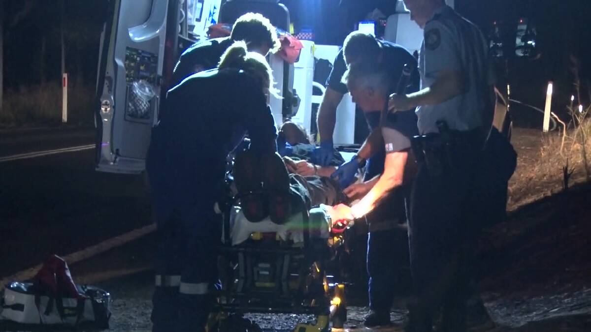 Treated: A man is treated by paramedics during the operation. Picture: TNV.