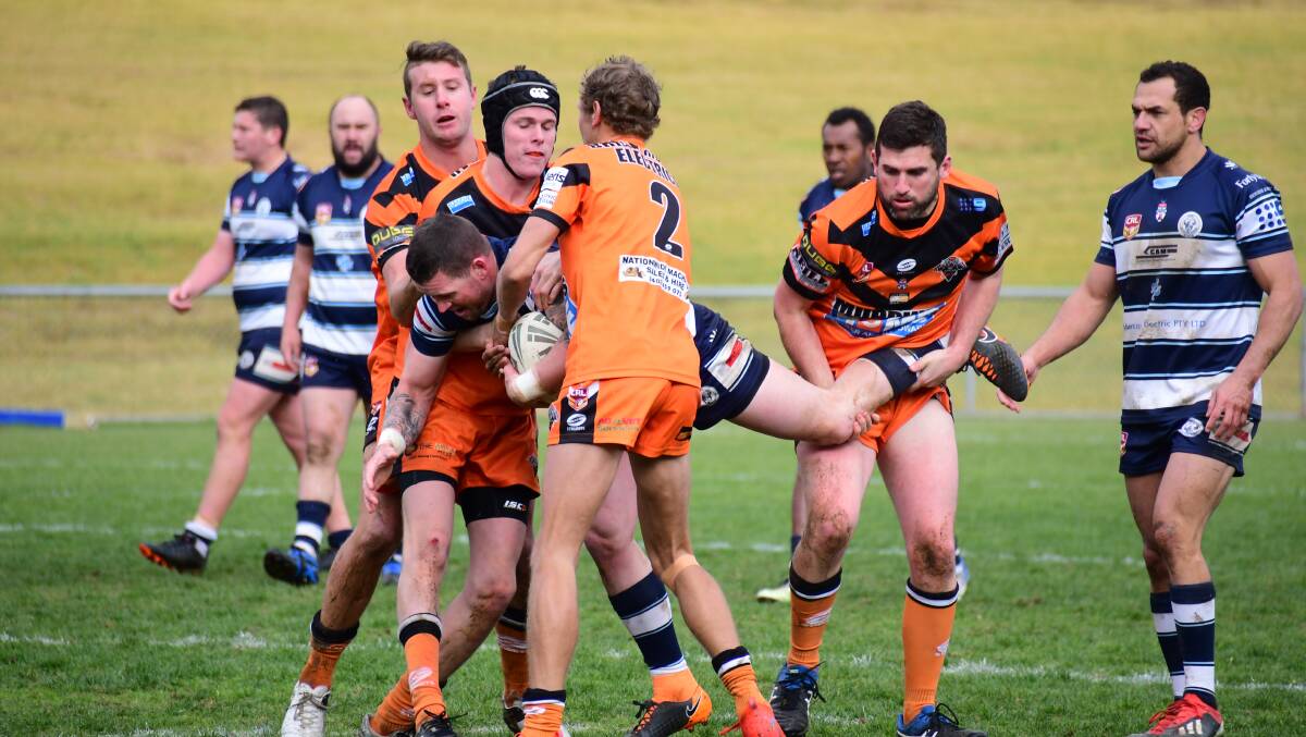Outmanned: The Macquarie Raider's Bradley Spencer is held up by the Tiger's defence. Photo: Amy McIntyre. 