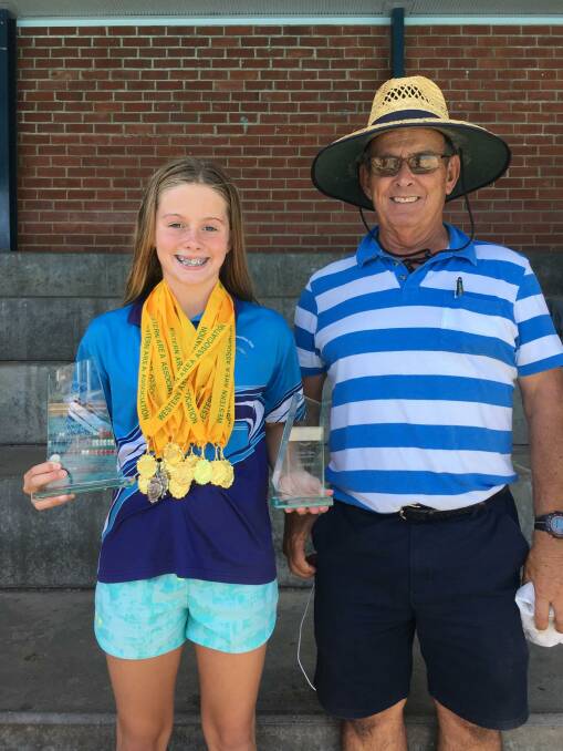 Maddie Marks with coach 'Whiskey' Andriske and her haul of medals at the 2018-19 Western Area Carnival in March. Photo: SUPPLIED
