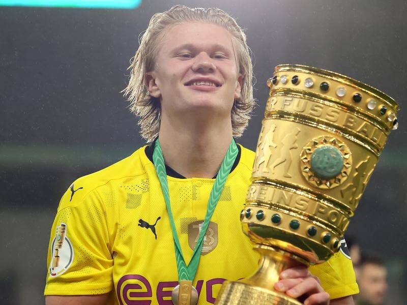 Borussia Dortmund's Erling Haaland holds the German Cup after his brace helped them beat Leipzig 4-1