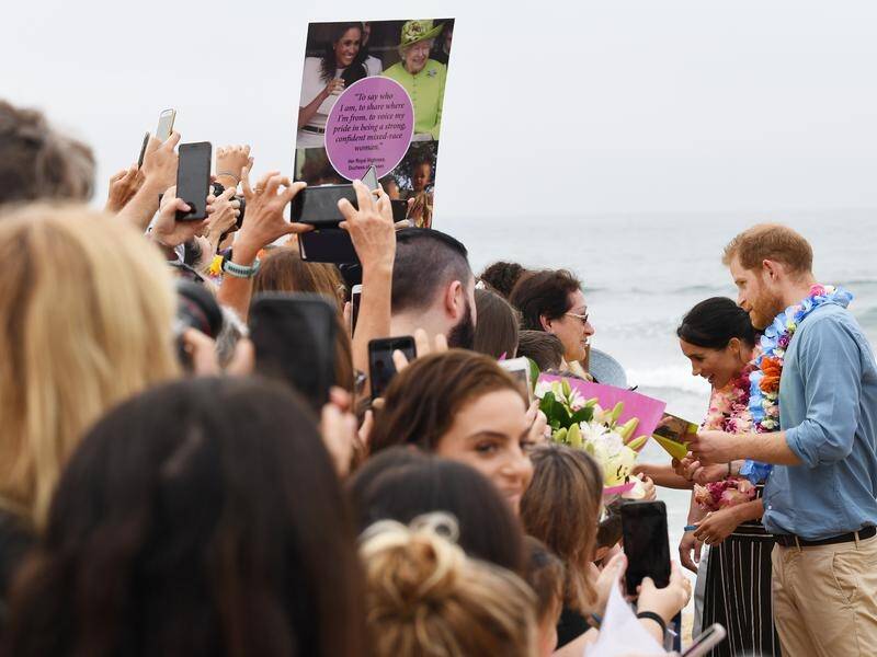 Prince Harry and Meghan took time to meet the people during a walk at Bondi Beach.