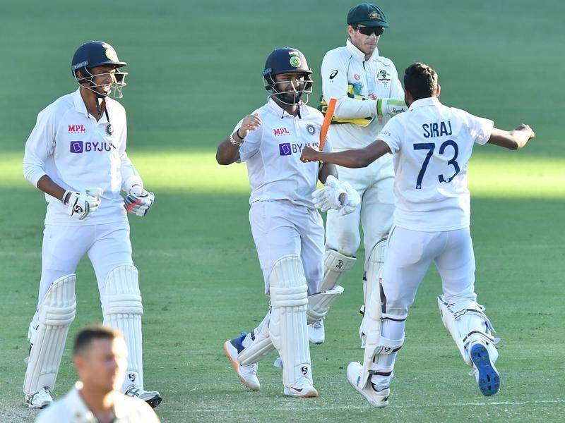 India's Rishabh Pant (c) celebrates with teammates after hitting the winning runs against Australia.