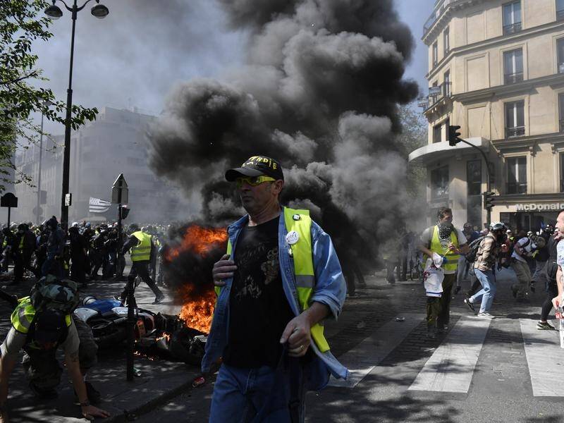 Yellow vests protesters have lit fires and clashed with police in Paris for the 23rd weekend.