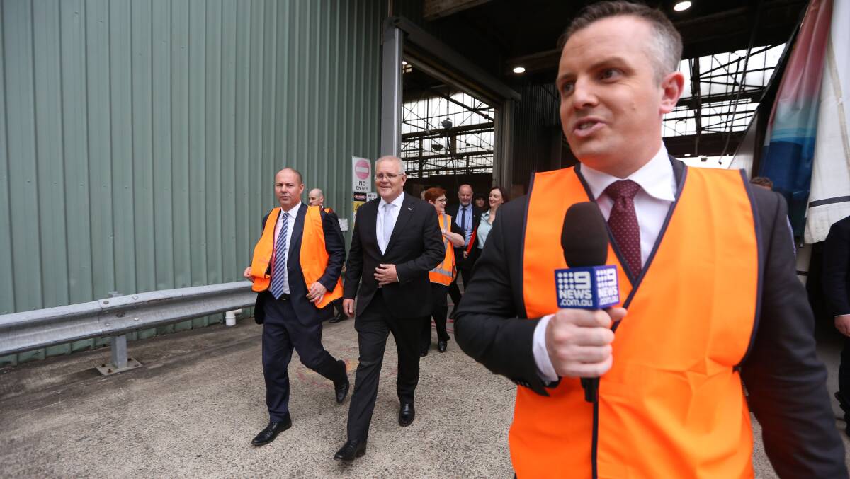 Prime Minister Scott Morrison (centre) and Treasurer Josh Frydenberg (left) run the media gauntlet during week one of the campaign. Picture: James Croucher